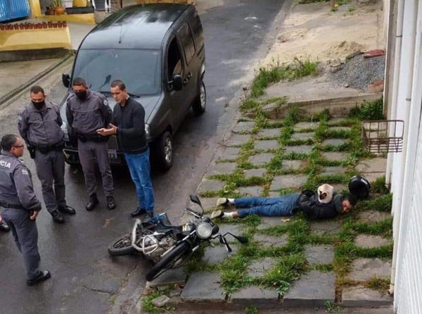 cats sleeping on arrested man's back