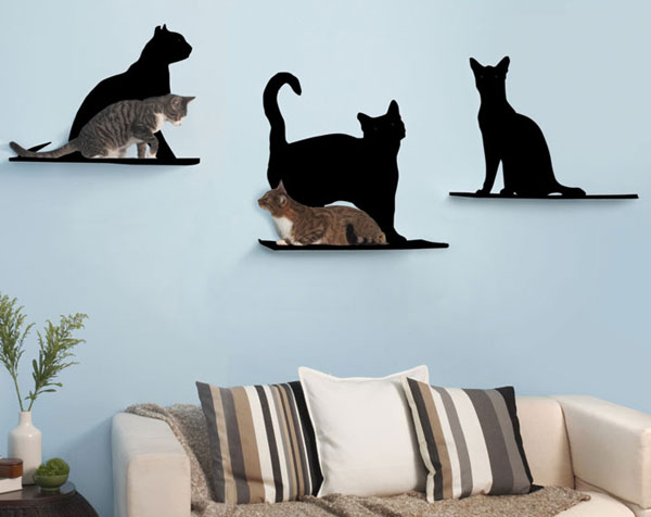 two cats on cat-shaped shelves