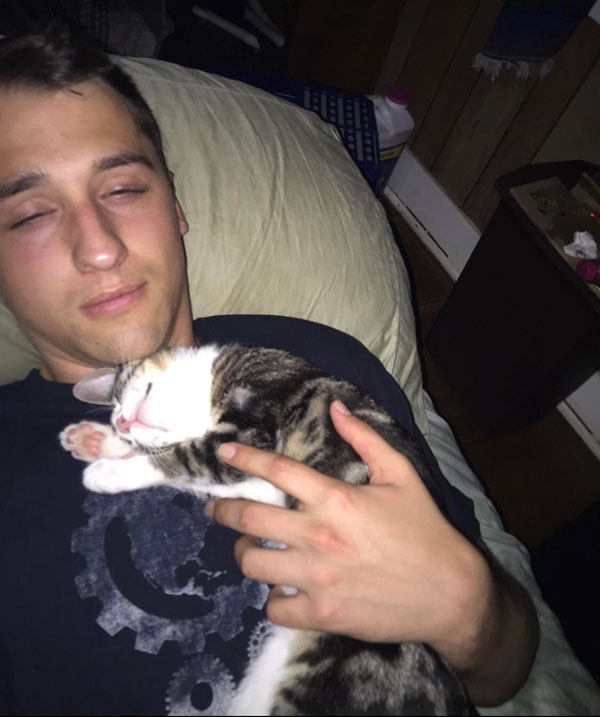 man trapped under sleeping cat