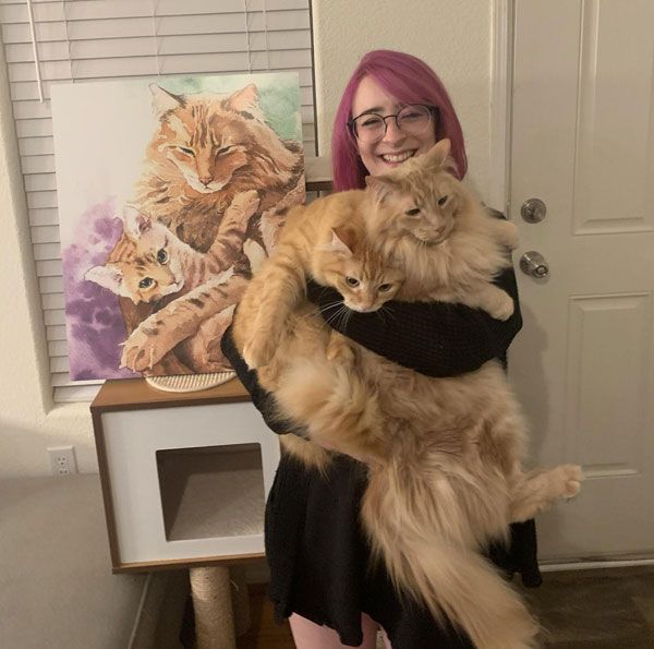 woman holding two really fluffy cats